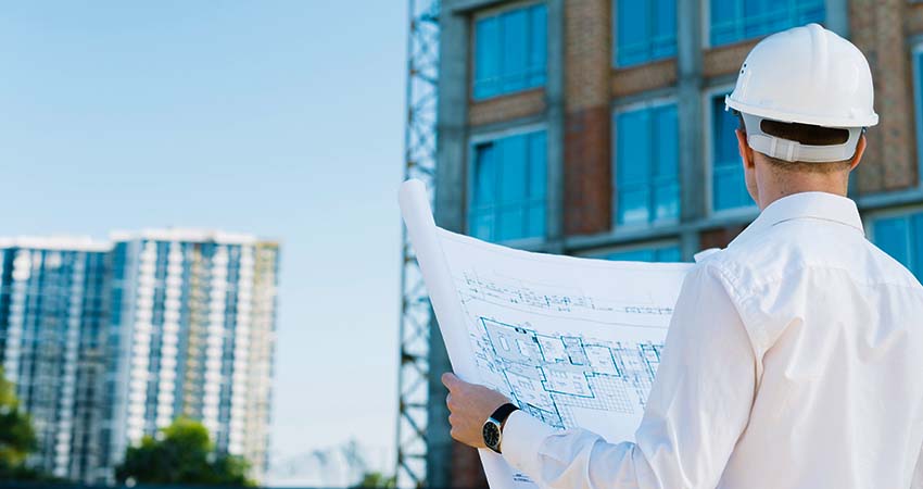 back-view-man-holding-building-plans